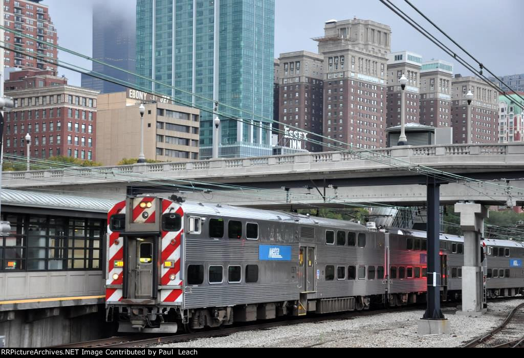 Outbound commuter approaches the station to makes its stop